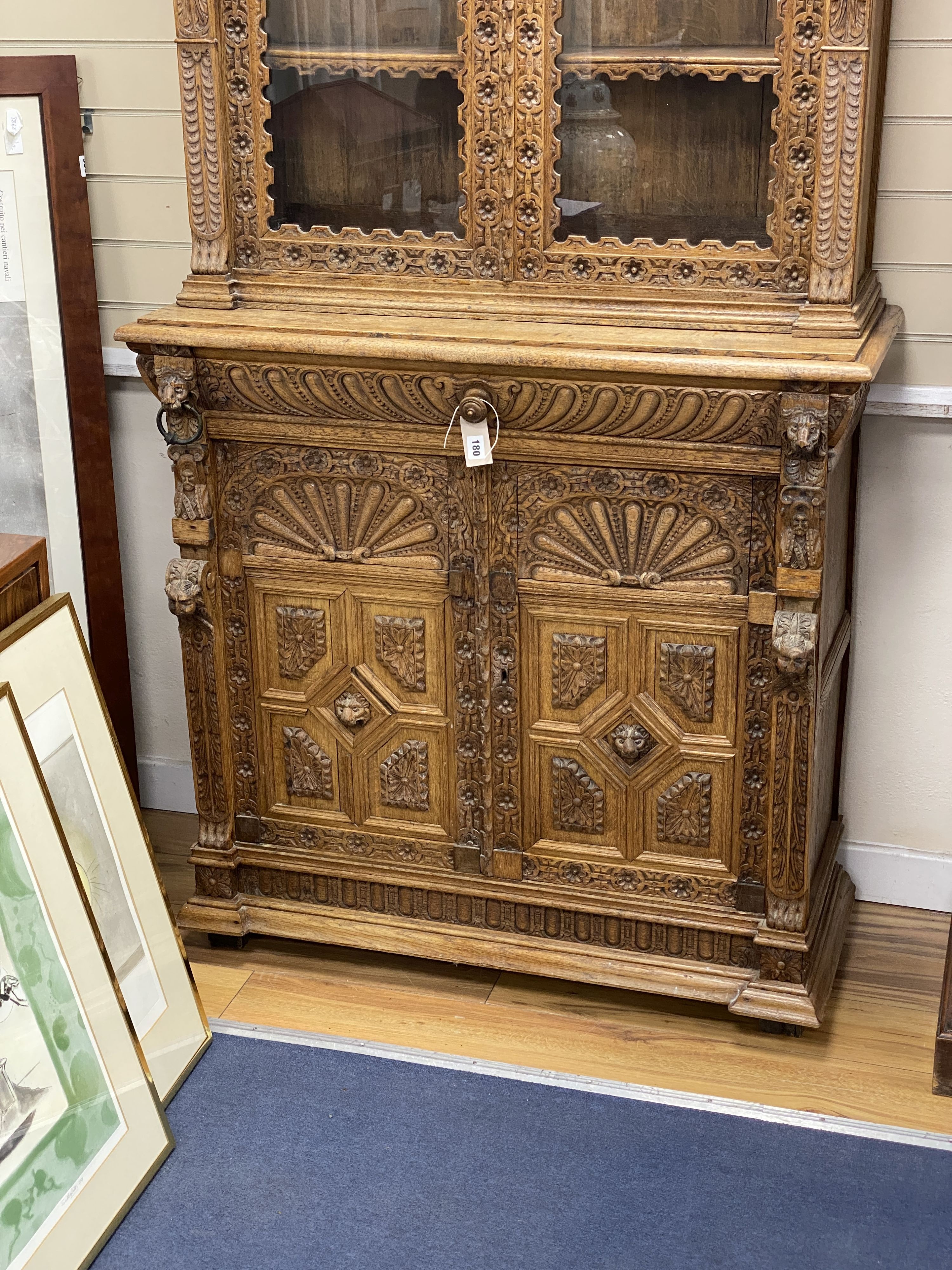 A late 19th century Flemish carved oak bookcase cupboard, width 102cm, depth 43cm, height 206cm